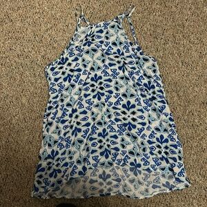 It’s a blue and white tank top with a pretty design and it’s never been worn